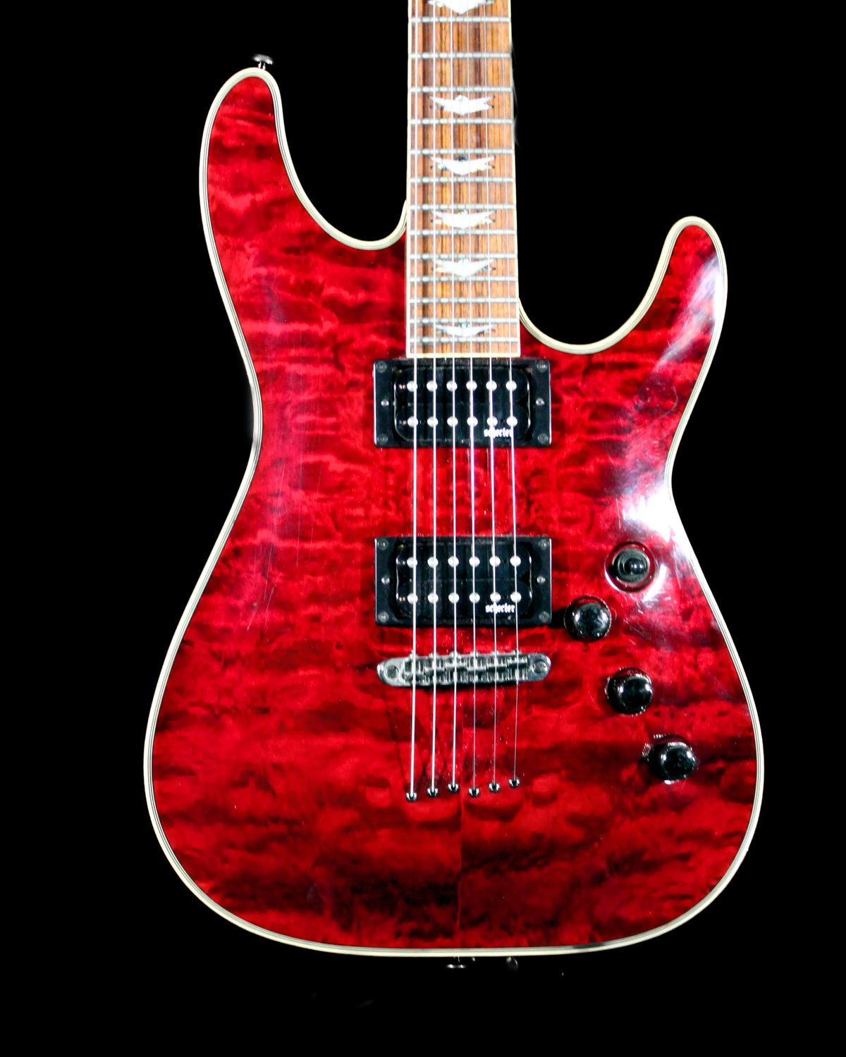 CDS Guitars Schecter Omen Extreme electric guitar with sleek black body and modern design, shown from a side view.