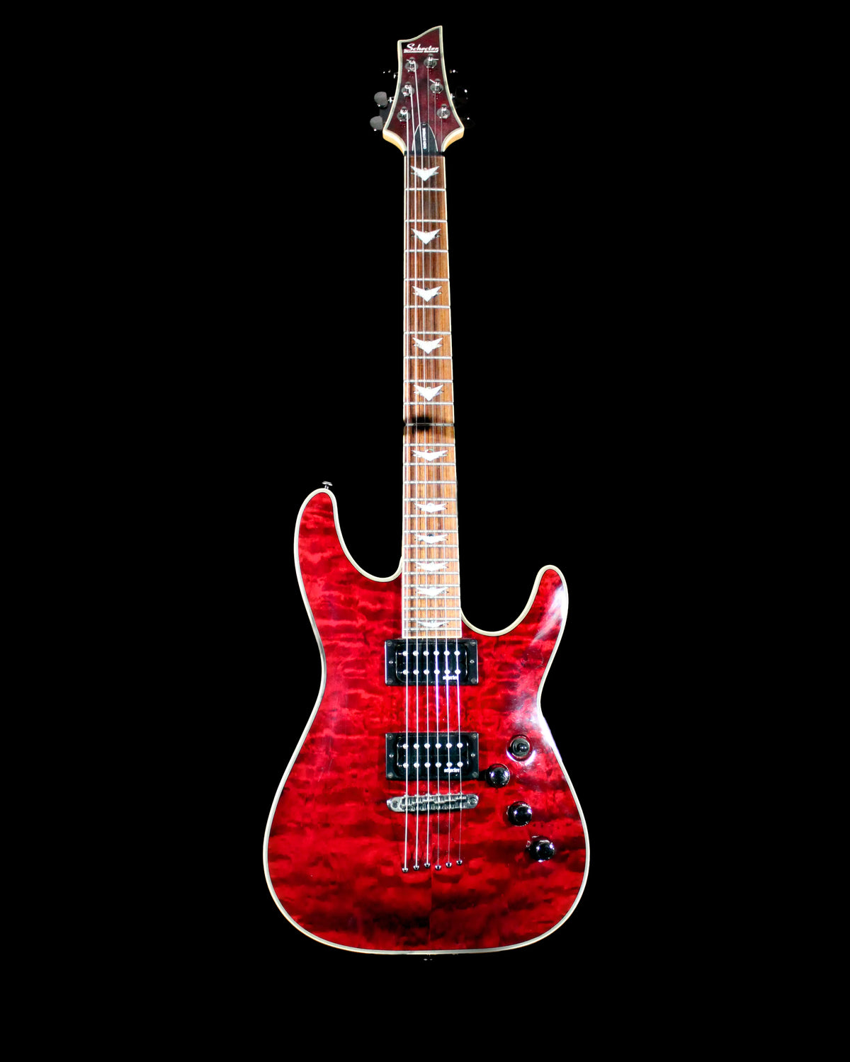 Schecter Omen Extreme electric guitar with sleek black finish and modern design, featuring dual humbucker pickups and a rosewood fretboard.
