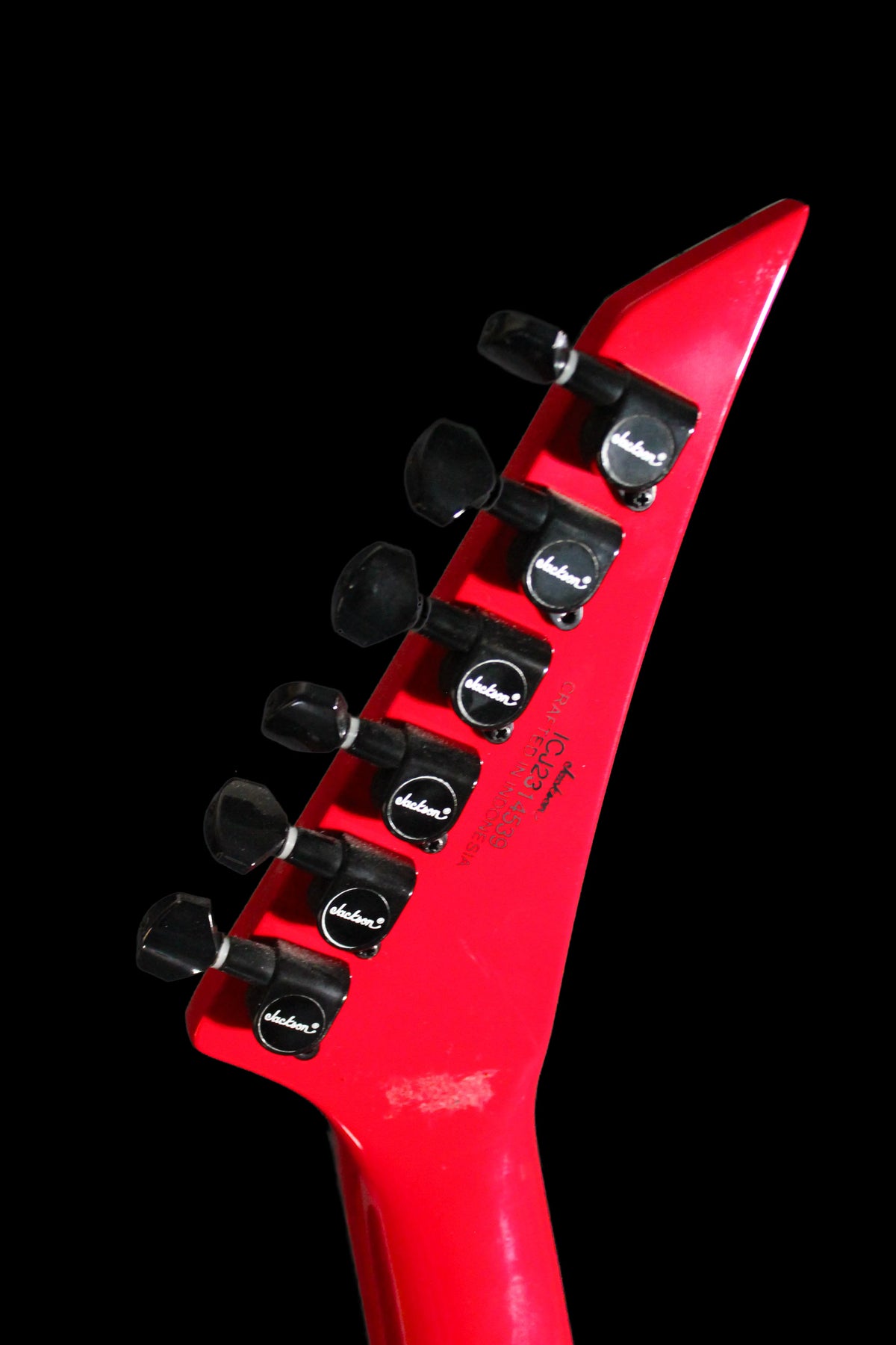 CDS Guitars Jackson RRX24 Rhoads electric guitar with sleek black finish and distinctive sharp body shape, close-up of the instrument.