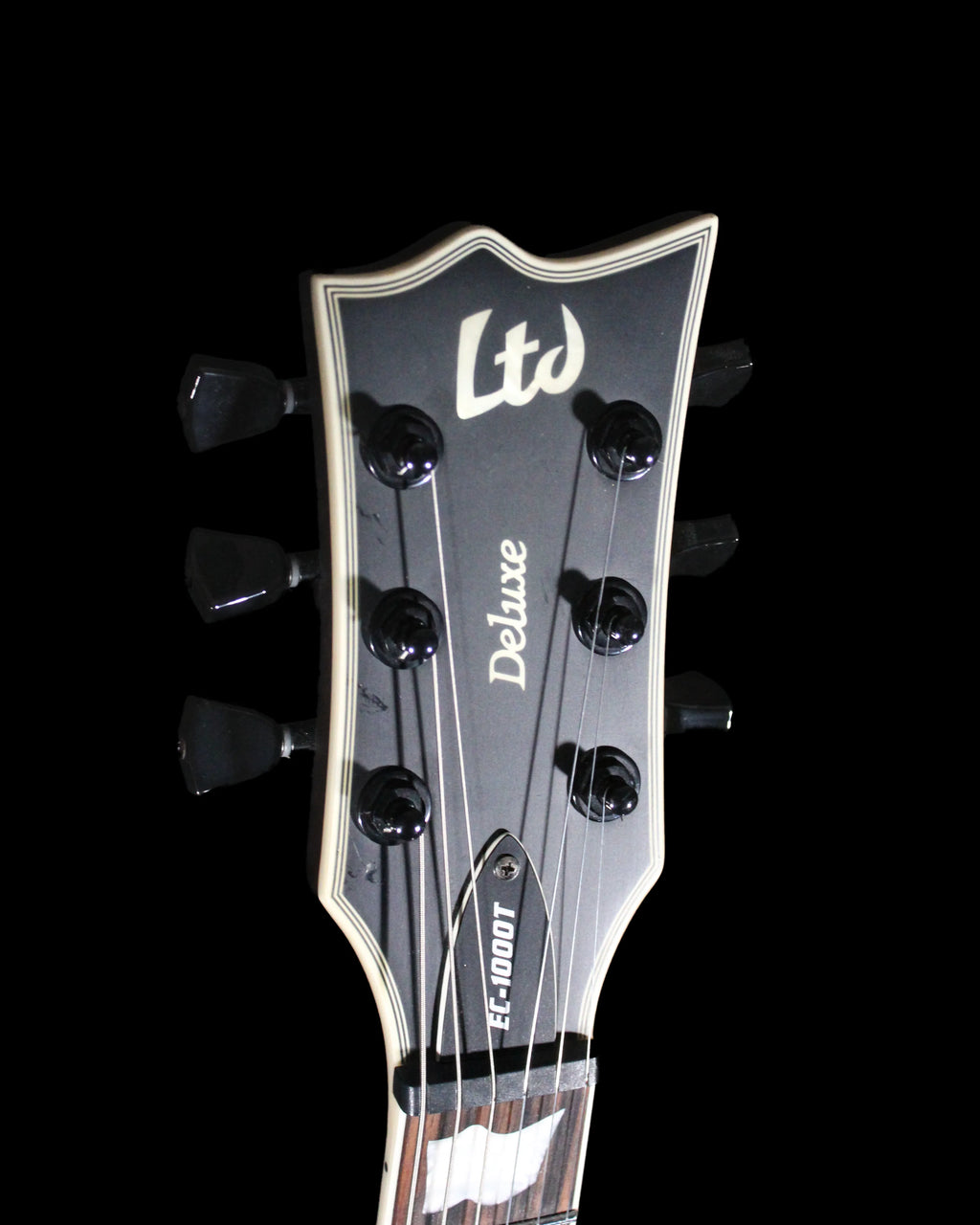 CDS Guitars ESP LTD EC-1000T electric guitar with sleek black finish and double-cutaway body, shown on a stand.